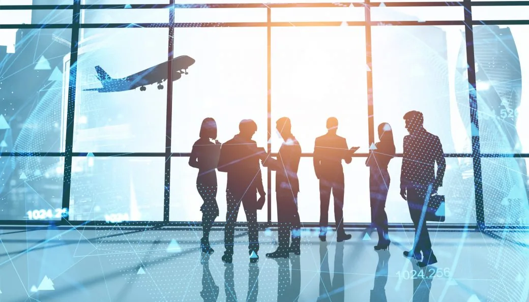 Silhouetted business travellers by an airport window with a plane and data graphics overlaid.